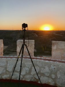a camera on the stand to capture sun set