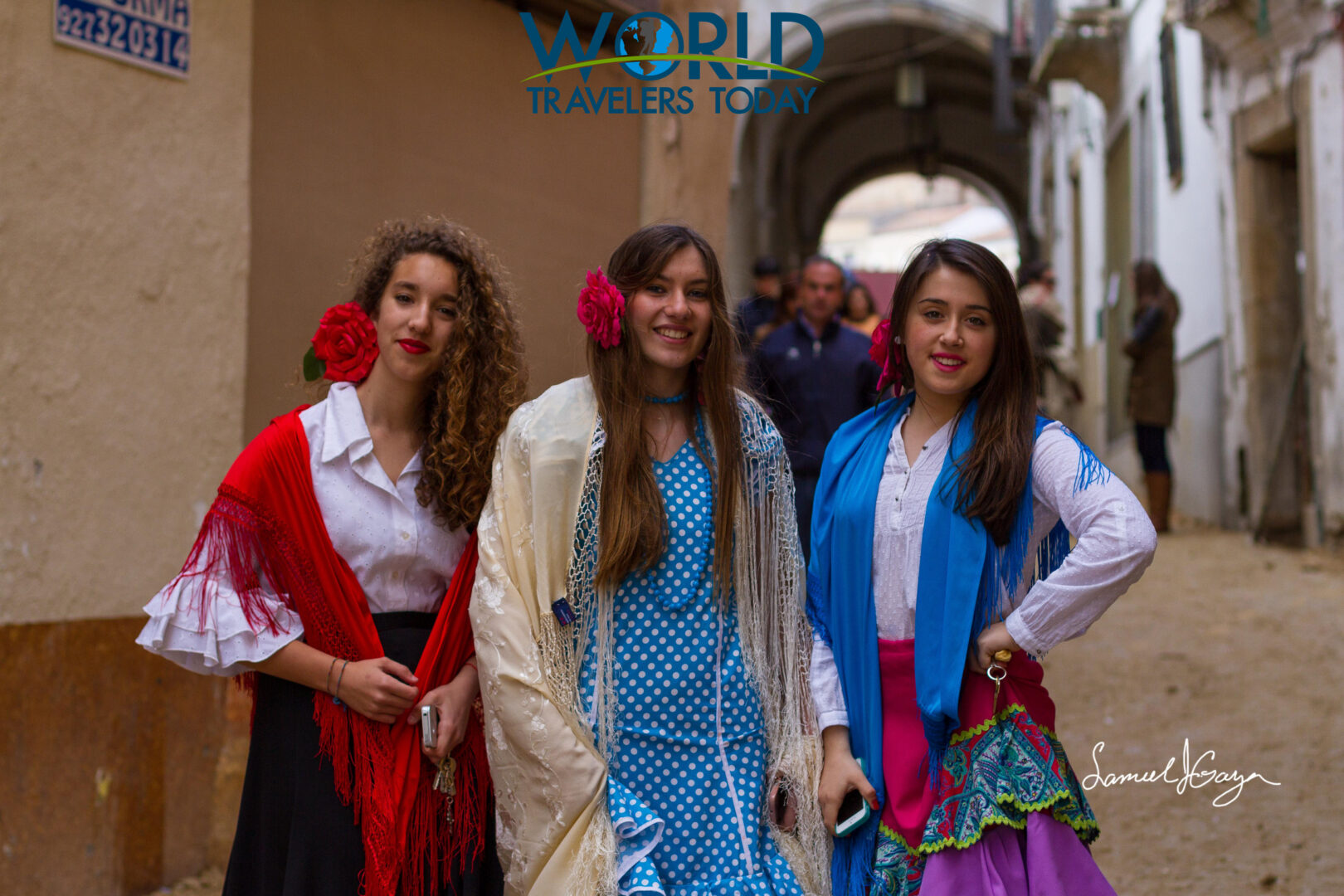 Three girls wearing spanish costume and roses in their hair