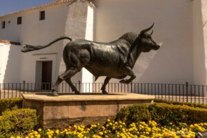 Statue of a black bull in front of a building